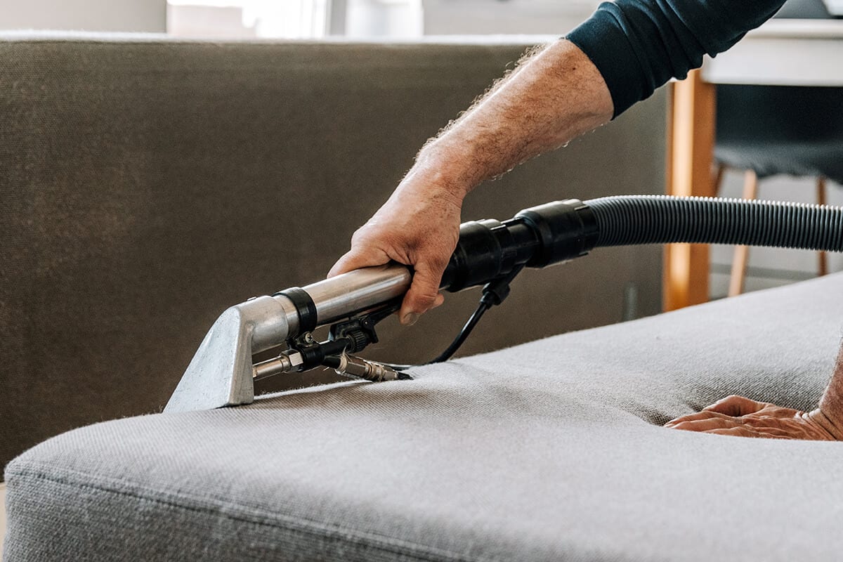 Professional cleaning service deep cleaning sofa at home.