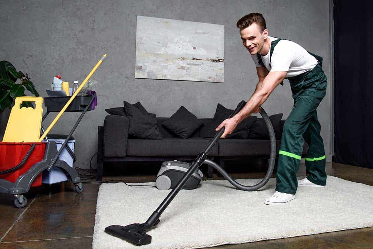 professional carpet cleaner cleaning a stained white carpet