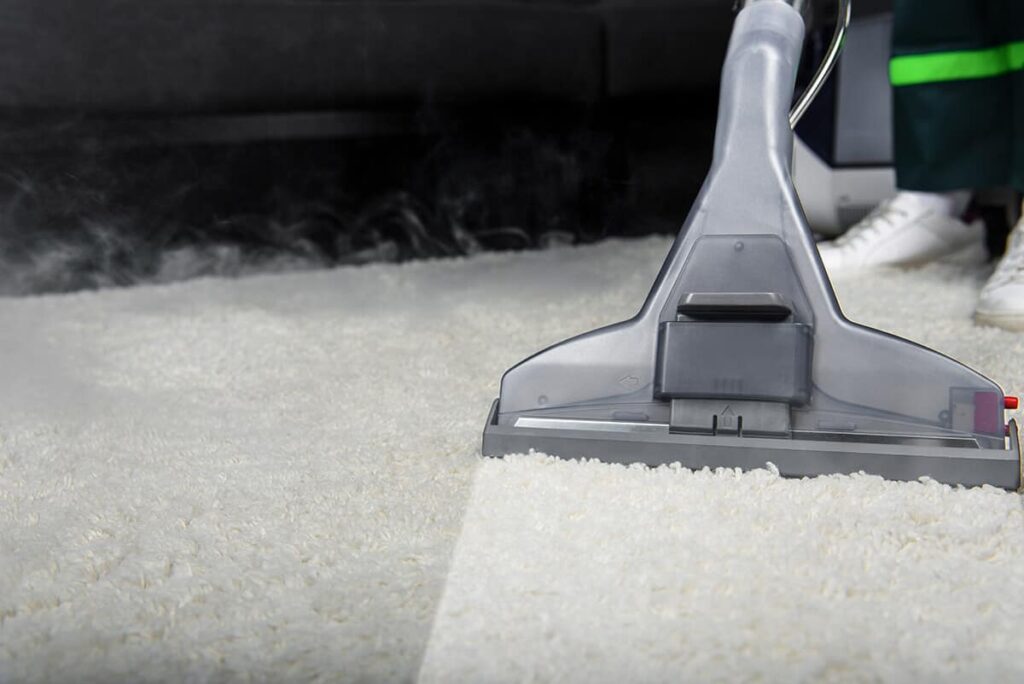 close up view of professional carpet cleaner vacuuming a carpet in Ilford