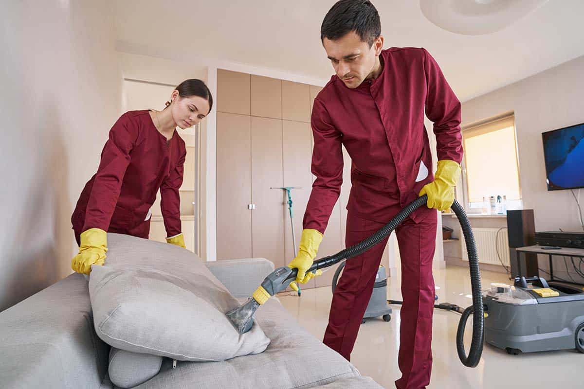 cleaners cleaning sofa as part of end of tenancy cleaning