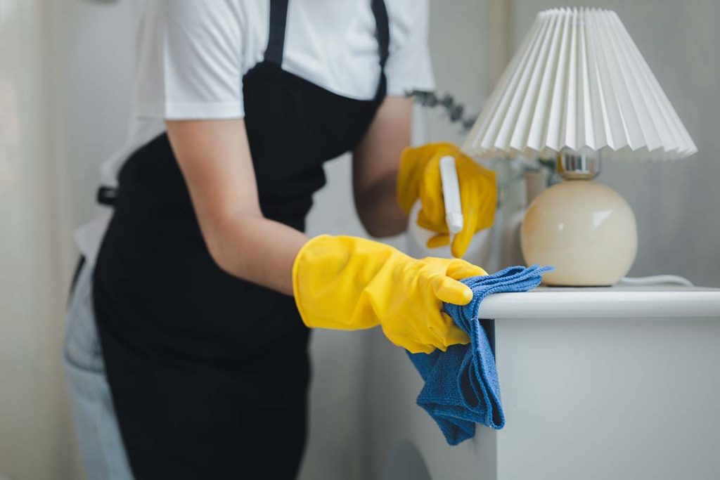 professional cleaner from Skycleaners cleaning a bedroom in london