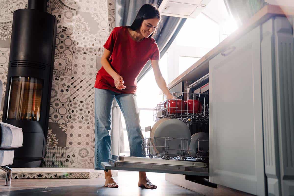 woman cleaning a dishwasher