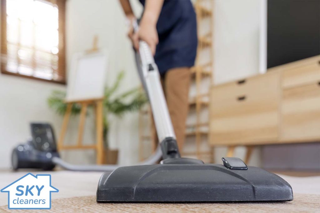 professional cleaner vacuuming a carpet