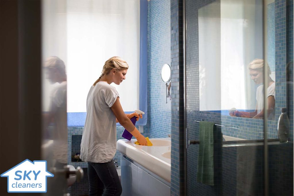 woman cleaning a bathroom