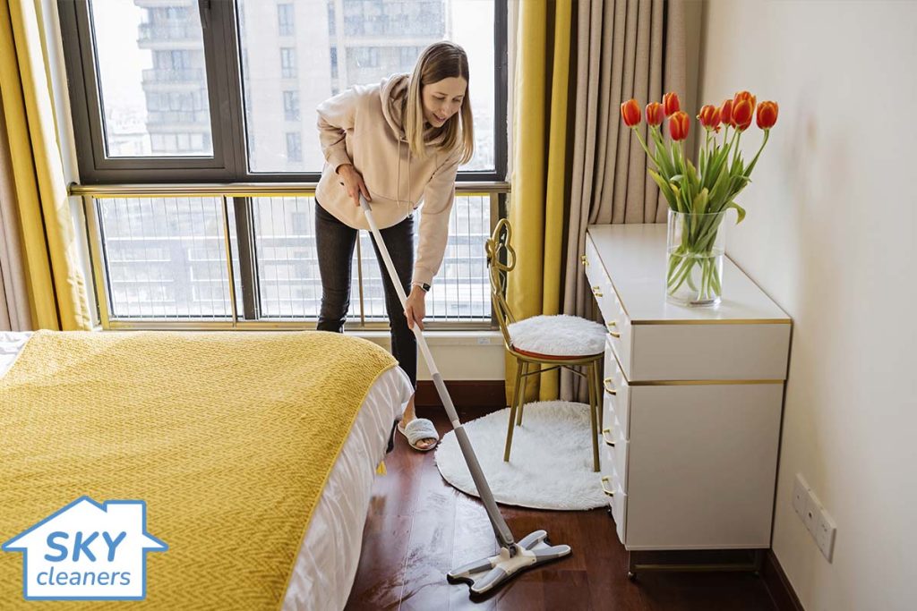 woman cleaning bedroom