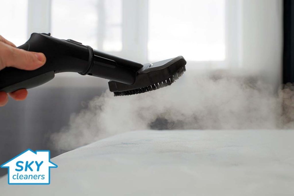 cleaner using steam cleaning on a mattress in london by skycleaners ltd